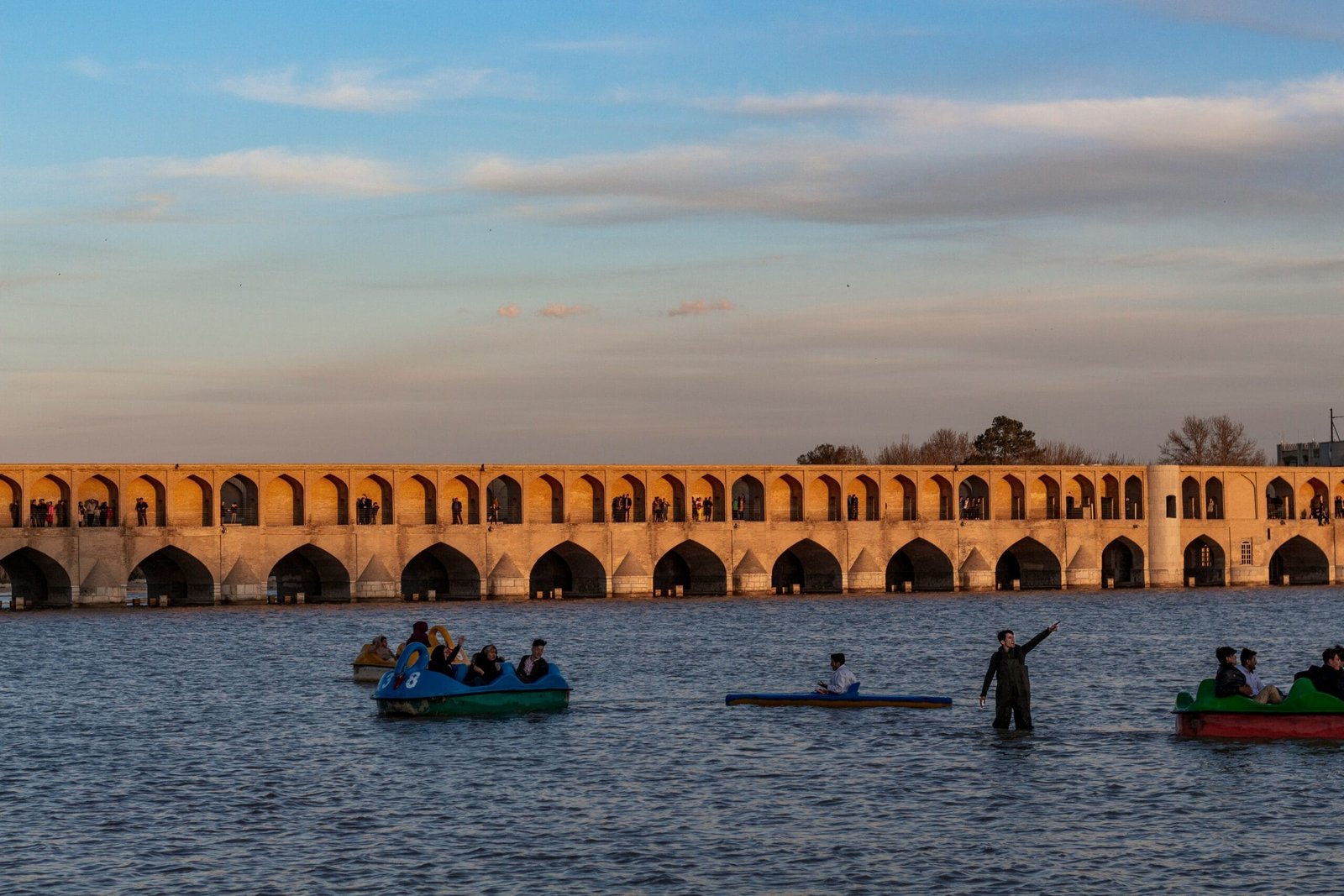 people riding on blue kayak on body of water during daytime